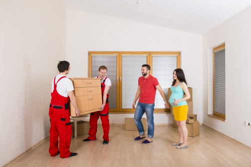 Local movers handling boxes and furniture near Tottenham Green