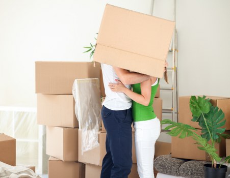 Team separating cardboard, wood, and metal from a clearance load
