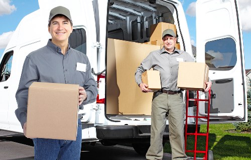 Driver handling boxes and household items for a local move